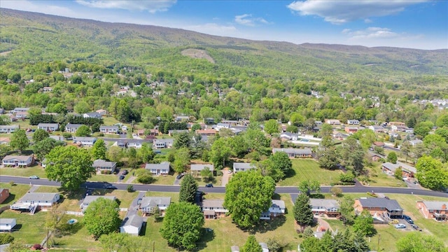 birds eye view of property with a residential view, a mountain view, and a forest view
