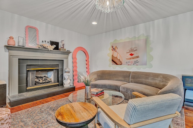 living area with a fireplace, wood finished floors, and recessed lighting