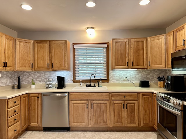 kitchen featuring backsplash, stainless steel appliances, and a sink