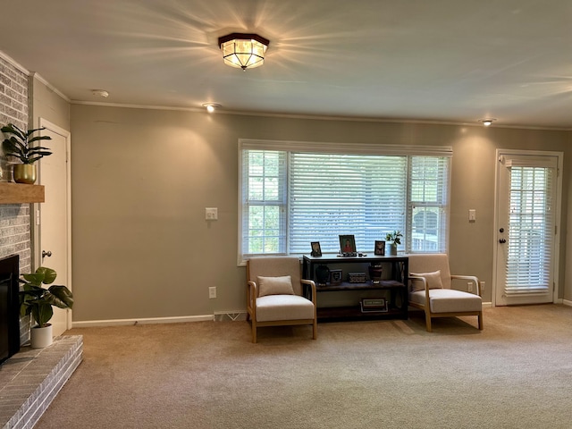 living area with baseboards, crown molding, carpet flooring, and a fireplace