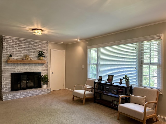 living area with a brick fireplace, carpet flooring, baseboards, and ornamental molding