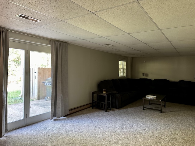 carpeted living room featuring baseboard heating, a drop ceiling, and visible vents