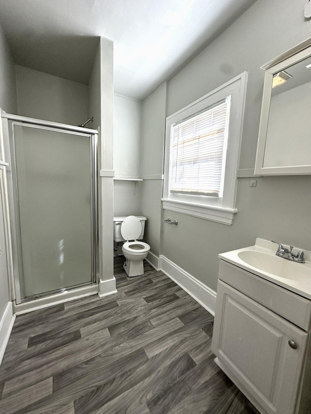 1414 Wise Ave SE, Roanoke, VA 24013 - full bathroom featuring a stall shower, toilet, baseboards, vanity, and wood finished floors