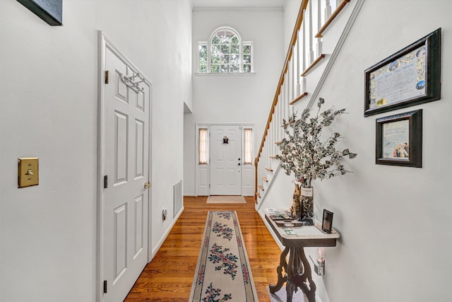 72 Windsor Ct, Roanoke, VA 24019 - doorway with stairs, wood finished floors, baseboards, and a towering ceiling