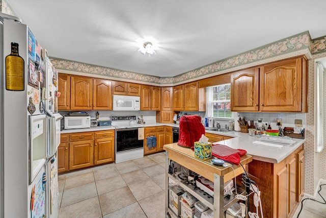 72 Windsor Ct, Roanoke, VA 24019 - kitchen with white appliances, light countertops, brown cabinetry, tasteful backsplash, and wallpapered walls