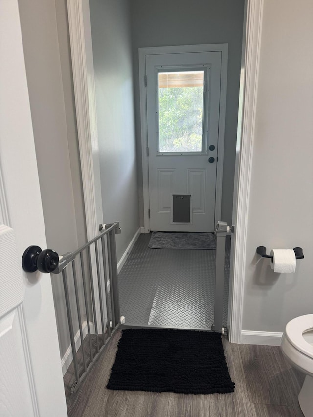 clothes washing area with cabinet space, baseboards, dark wood-style flooring, and washer and clothes dryer