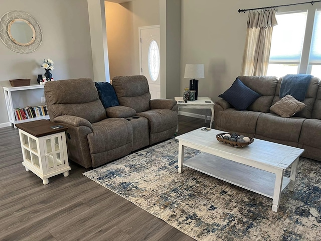living room featuring dark wood finished floors, a wealth of natural light, and baseboards