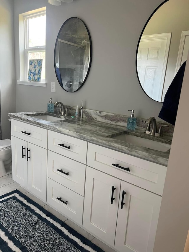 full bath featuring a shower stall, marble finish floor, vanity, and toilet