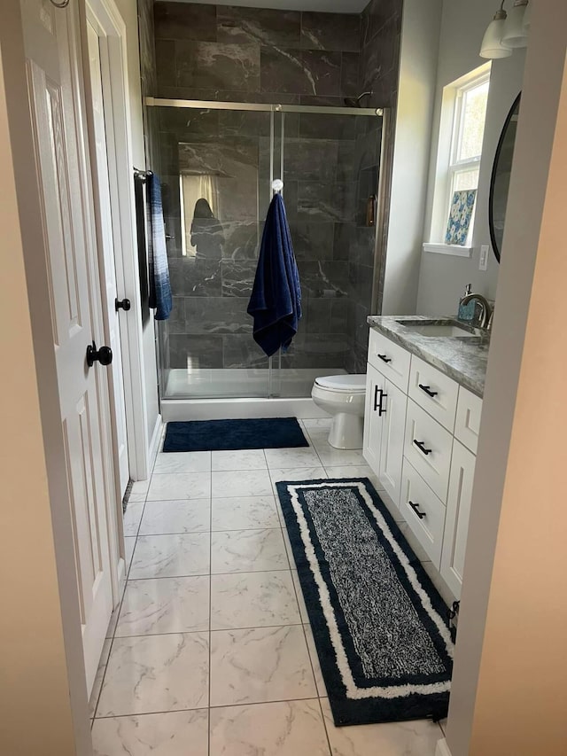 bathroom with wood finished floors, vanity, toilet, and baseboards