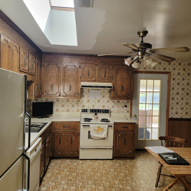 1106 Hogan Rd, Blue Ridge, VA 24064 - kitchen featuring white appliances, light countertops, a ceiling fan, wallpapered walls, and under cabinet range hood