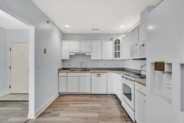 4444 Pheasant Ridge Rd Unit 206, Roanoke, VA 24014 - kitchen with a sink, light wood finished floors, white appliances, white cabinetry, and glass insert cabinets