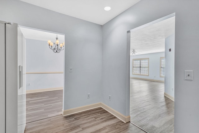 4444 Pheasant Ridge Rd Unit 206, Roanoke, VA 24014 - unfurnished room with baseboards, wood finished floors, and a notable chandelier