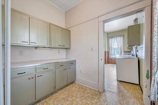kitchen featuring light floors, baseboards, and light countertops
