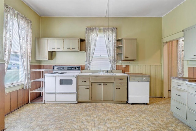 kitchen with a sink, white electric range oven, open shelves, a wainscoted wall, and light countertops