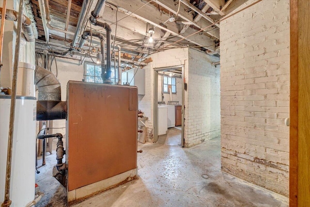 basement featuring washer and dryer and water heater