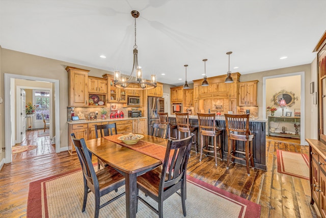 dining room featuring baseboards, an inviting chandelier, recessed lighting, and dark wood finished floors