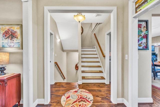 stairway with baseboards and wood finished floors