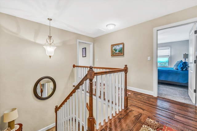 staircase with wood finished floors and baseboards