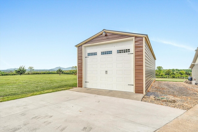 detached garage with driveway and a mountain view