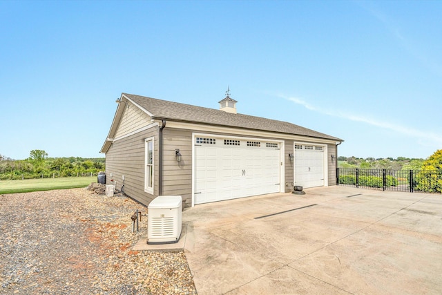 detached garage featuring fence