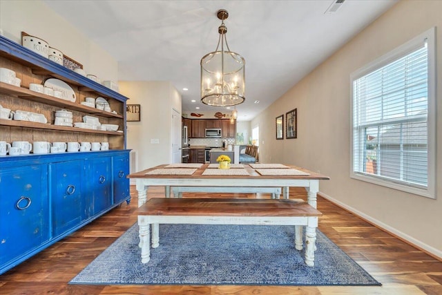 dining space featuring dark wood finished floors, healthy amount of natural light, baseboards, and recessed lighting