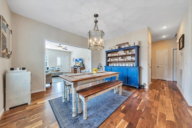 dining space featuring a chandelier, wood finished floors, a ceiling fan, baseboards, and recessed lighting