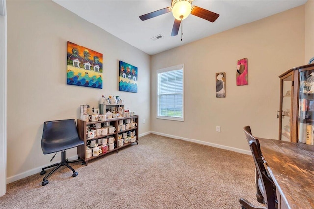 office area with carpet flooring, a ceiling fan, and baseboards
