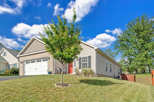 view of front of property featuring driveway, a garage, a front lawn, and brick siding