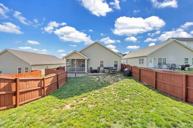 rear view of property featuring a sunroom and a patio