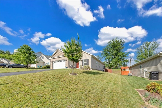 view of front facade with asphalt driveway, a front lawn, and a garage
