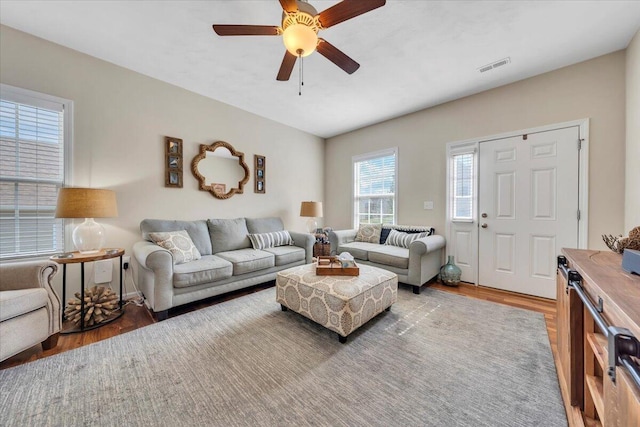 living area featuring wood finished floors and ceiling fan