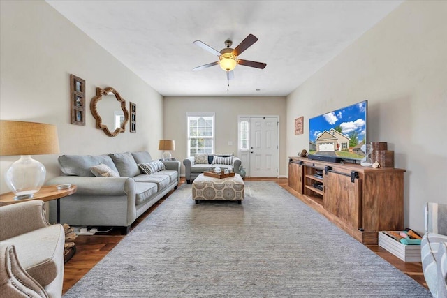 living room with wood finished floors and a ceiling fan