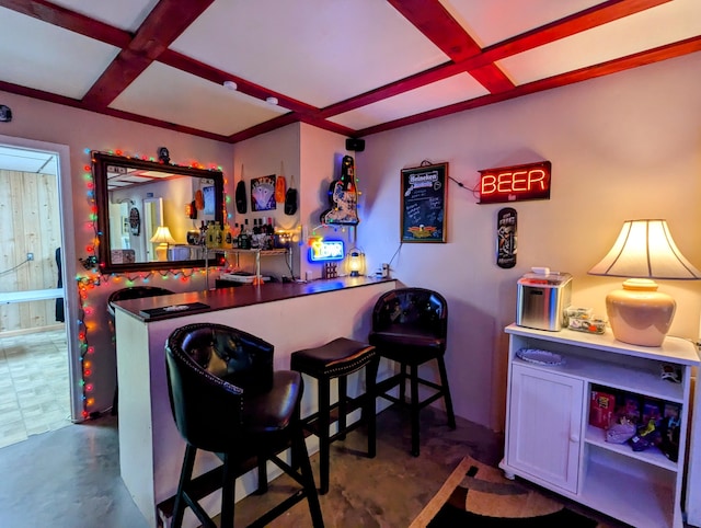 bar featuring beamed ceiling, a bar, and coffered ceiling