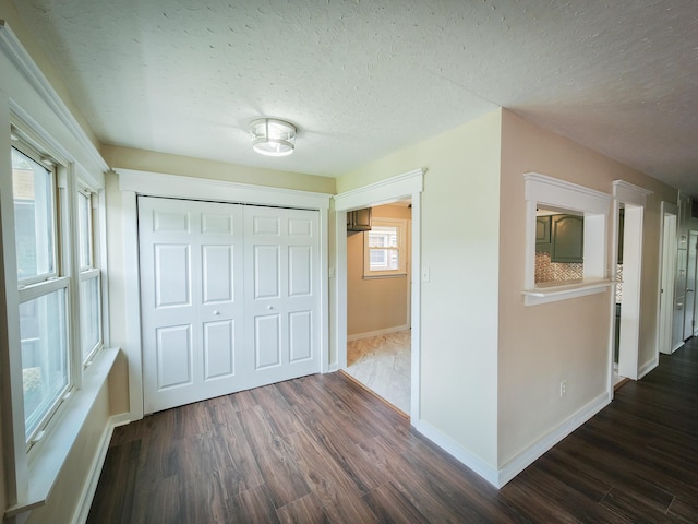 1322 S David Ave, Covington, VA 24426 - interior space featuring a textured ceiling, dark wood finished floors, a closet, and baseboards
