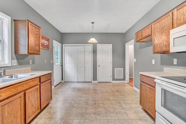 1920 Connors Ct, Salem, VA 24153 - kitchen featuring white appliances, light countertops, a sink, and brown cabinets