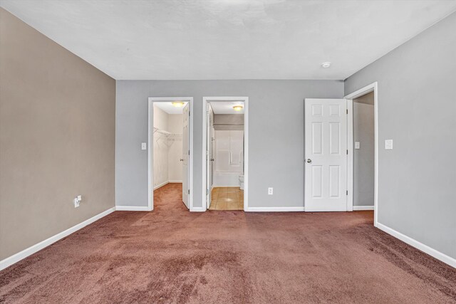 1920 Connors Ct, Salem, VA 24153 - unfurnished bedroom featuring a walk in closet, carpet flooring, baseboards, and a closet
