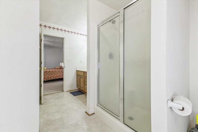 ensuite bathroom featuring ensuite bathroom, vanity, and a stall shower