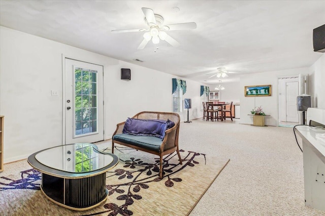 living area with visible vents, carpet flooring, and ceiling fan