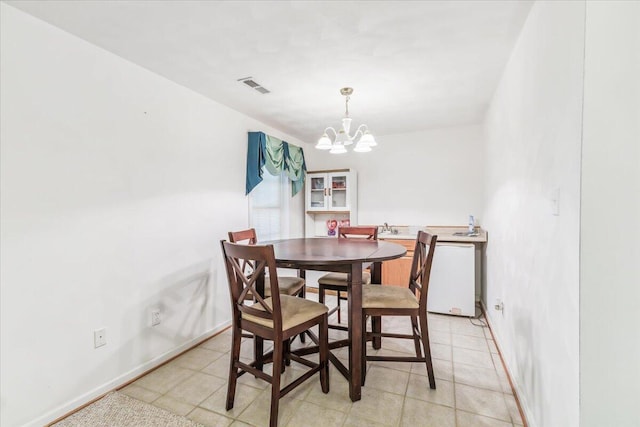 dining room featuring baseboards, a chandelier, and visible vents