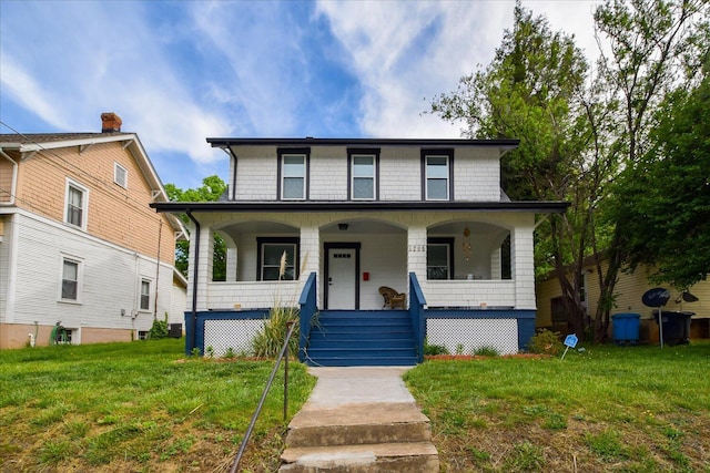 traditional style home featuring a porch and a front yard