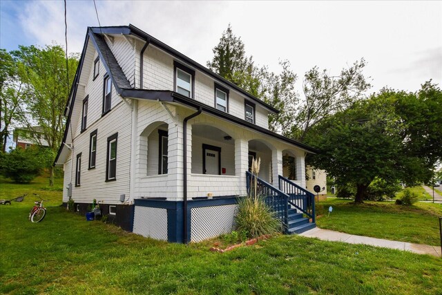 view of front of house with a front lawn and covered porch