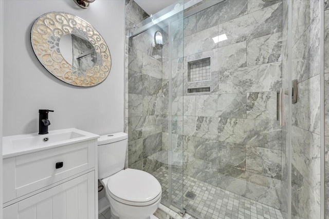 full bath with toilet, vanity, and a stall shower