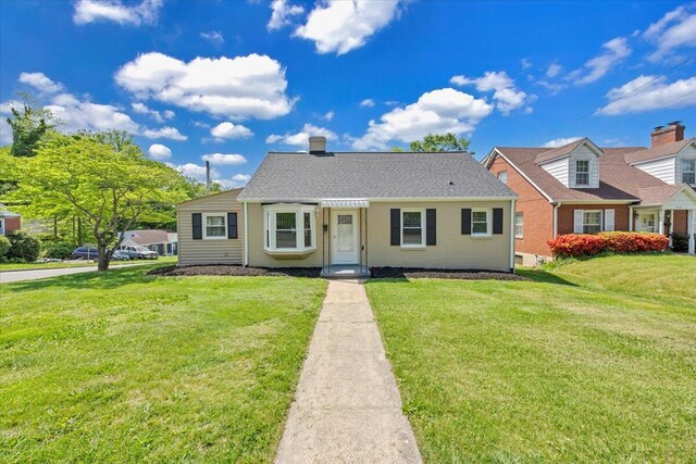 view of front of home featuring a chimney and a front yard