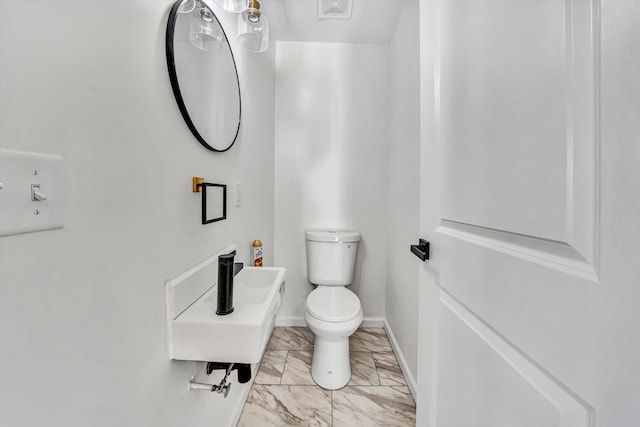 2288 Mud Pike Rd, Christiansburg, VA 24073 - half bathroom featuring toilet, marble finish floor, and baseboards