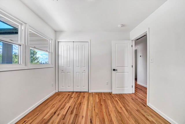 2288 Mud Pike Rd, Christiansburg, VA 24073 - unfurnished bedroom with a closet, light wood-style flooring, and baseboards