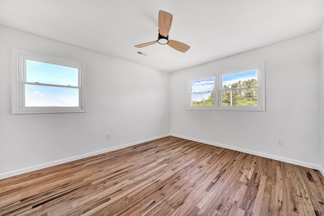 2288 Mud Pike Rd, Christiansburg, VA 24073 - spare room featuring wood finished floors, visible vents, ceiling fan, and baseboards
