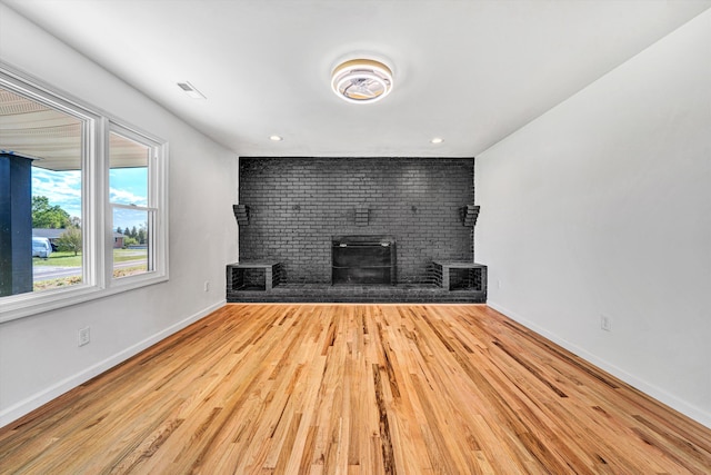 2288 Mud Pike Rd, Christiansburg, VA 24073 - unfurnished living room with a brick fireplace, recessed lighting, wood finished floors, and baseboards