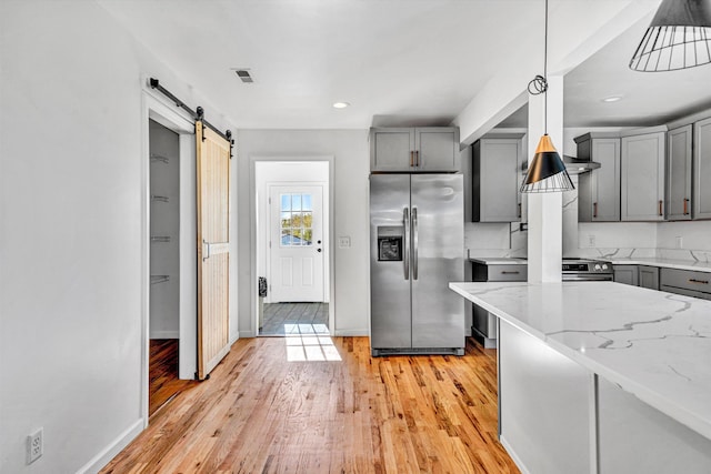 2288 Mud Pike Rd, Christiansburg, VA 24073 - kitchen featuring gray cabinetry, a barn door, stainless steel refrigerator with ice dispenser, and light stone countertops