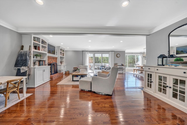 living room featuring crown molding, dark wood-style floors, and a fireplace