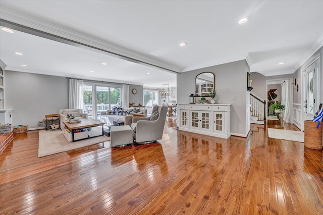 living room with crown molding, recessed lighting, hardwood / wood-style flooring, and stairway
